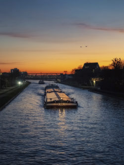 Frachtschiff auf dem Dortmund-Ems-Kanal in Münster bei Sonnenuntergang, fotografiert von Thomas Branse.